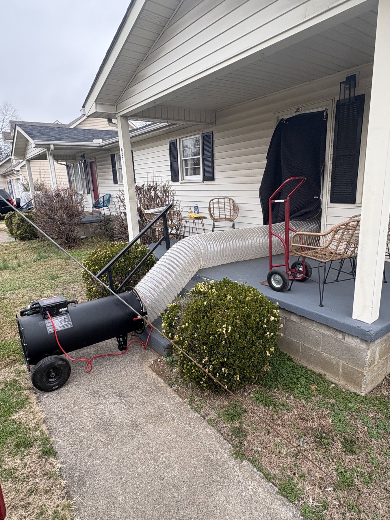 EcoForce bed bug heat treatment unit ducted into a home from the front porch