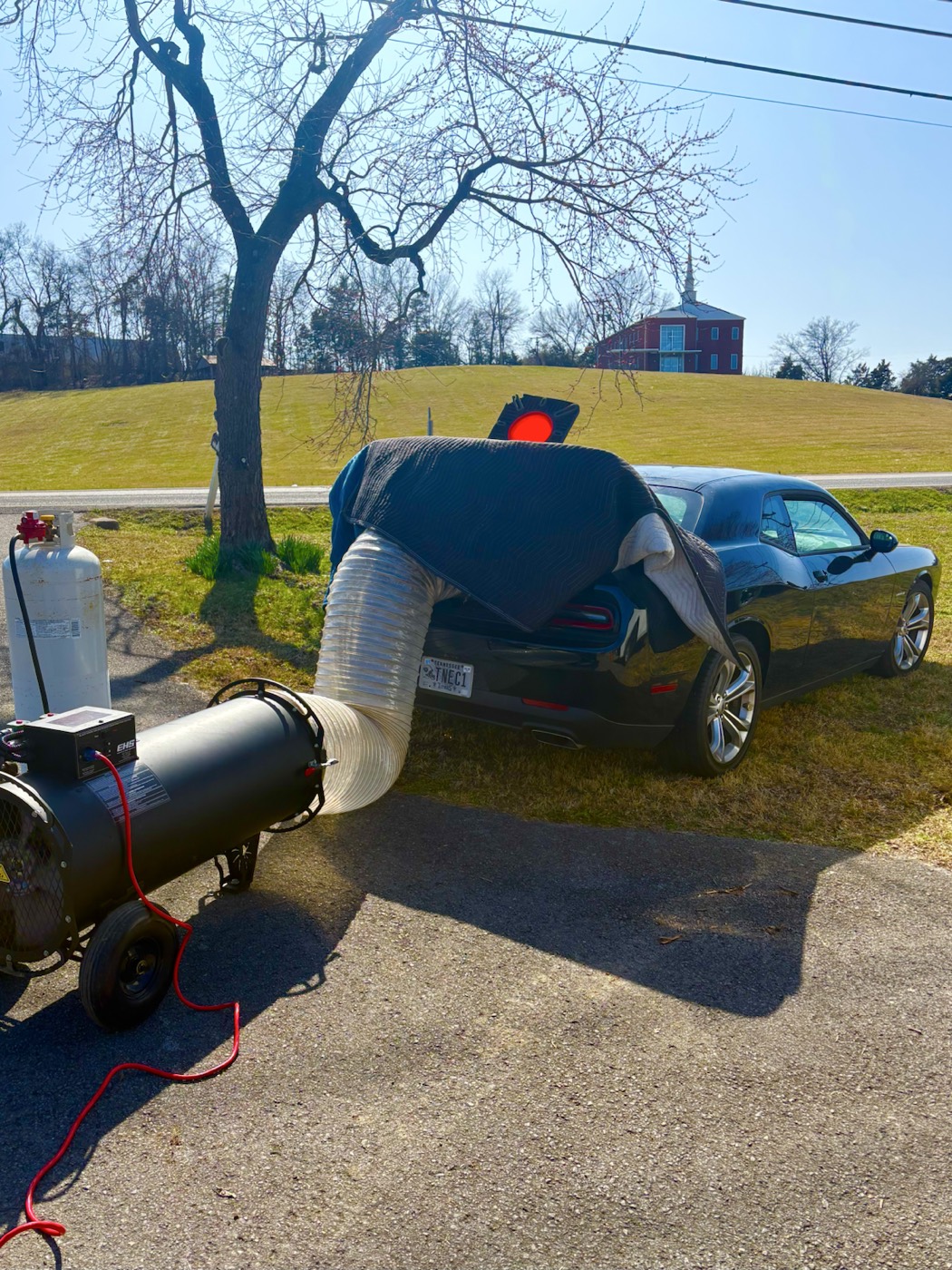EcoForce treatment hose feeding into a vehicle trunk area