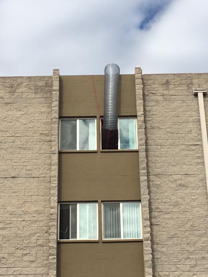 EcoForce ducting fed into an upper-floor window during a difficult bed bug heat treatment job